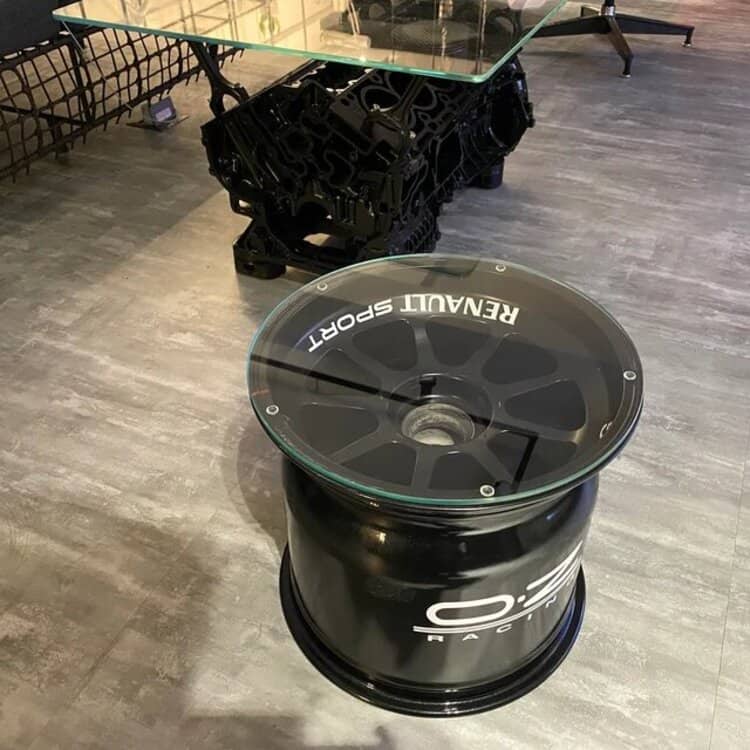Race used car parts made into beautiful f1 memorabilia. In this customer picture you can see a engine coffe table and a f1 wheel turned into a table.